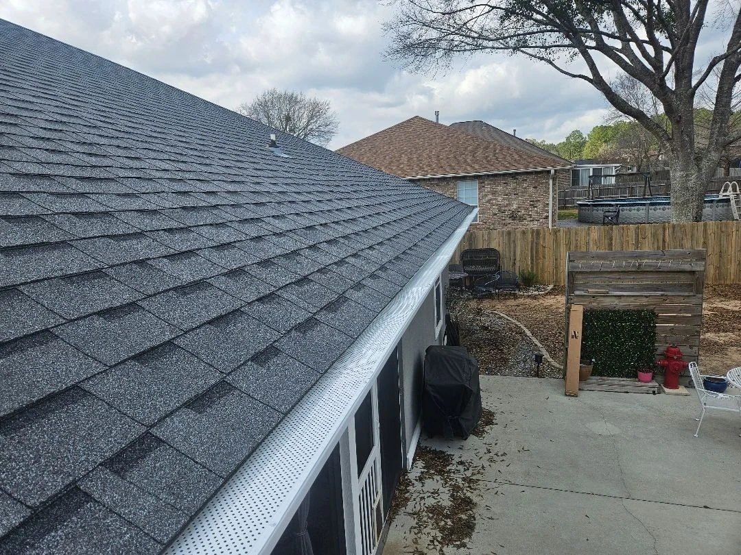 Roofline with leaf-guard gutter protection installed.