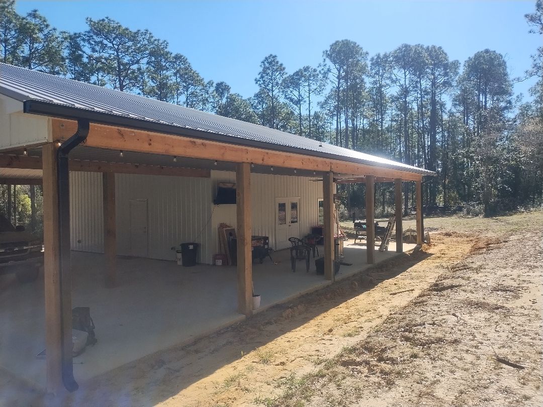 Covered patio roofline with gutter and downspout work.