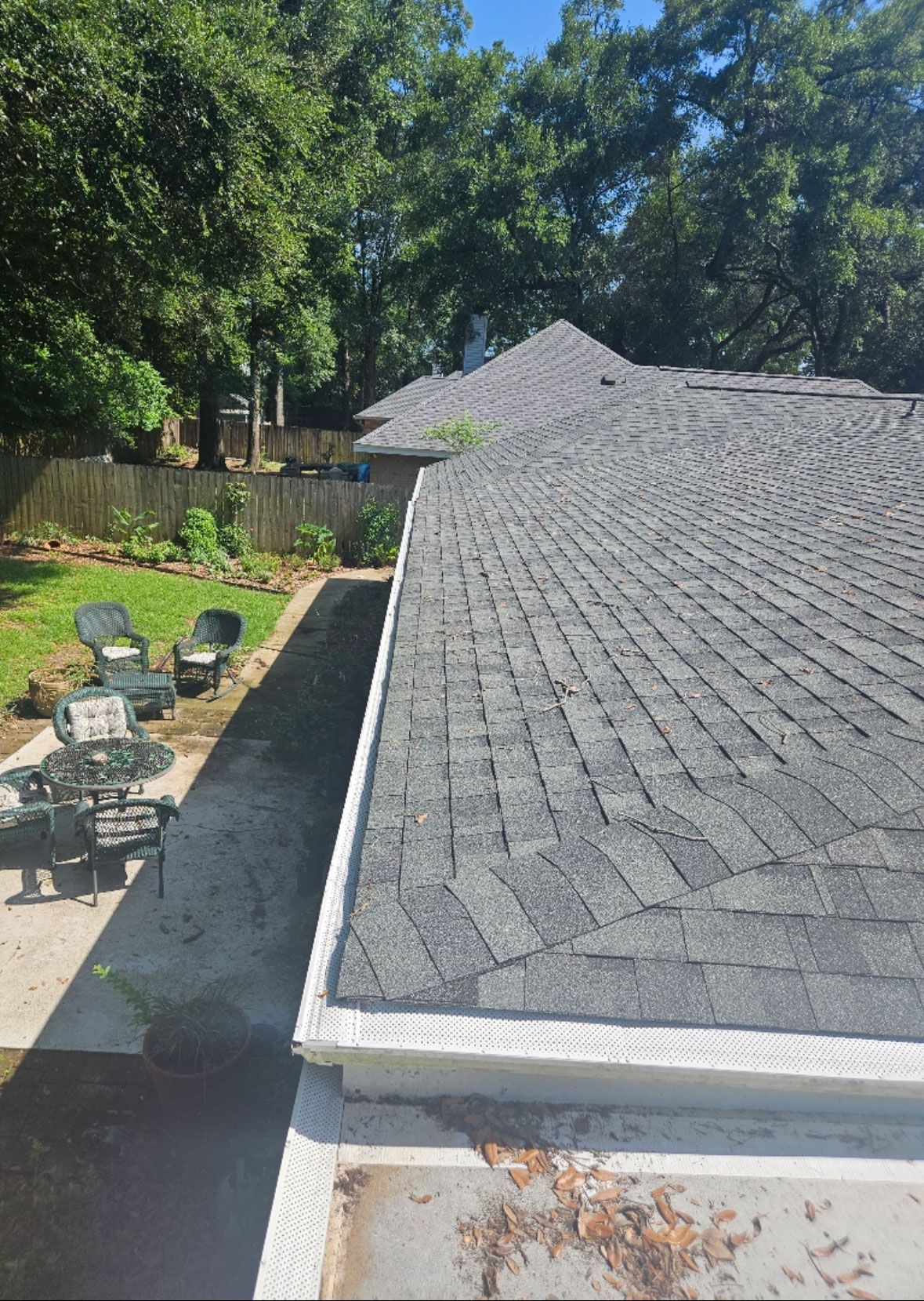 Portrait view of roofline with gutter installation.
